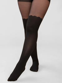 Black Scalloped over the knee from Rachel tights shown on a model's legs against a light gray studio background.