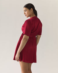 Woman wearing a pomegranate red dress