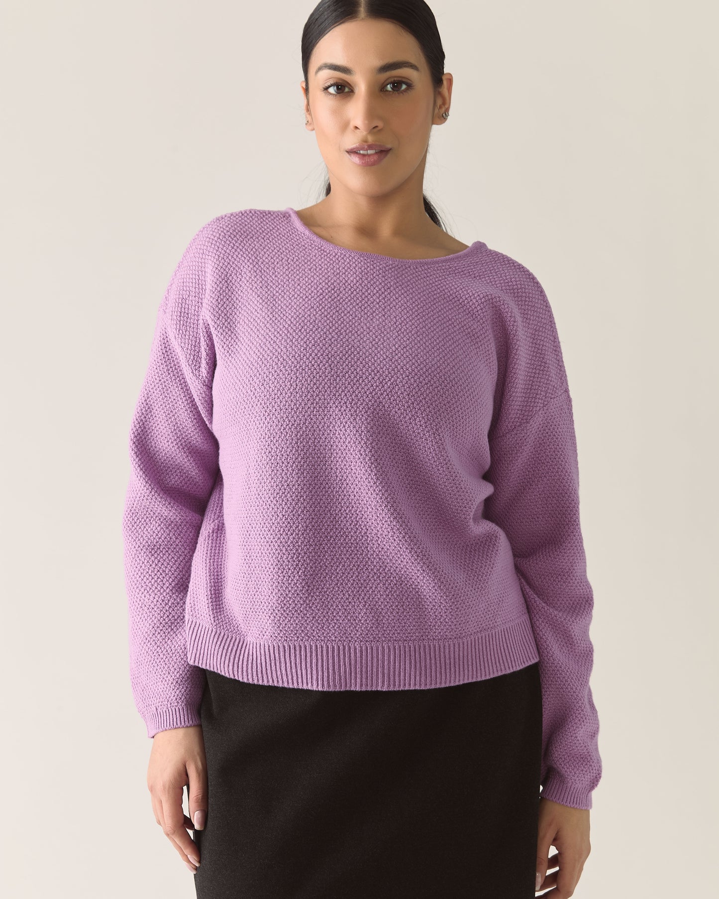 Woman wearing a lilac purple cardigan sweater