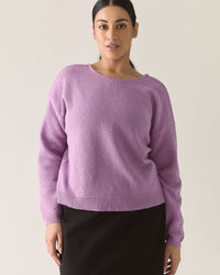Woman wearing a lilac purple cardigan sweater