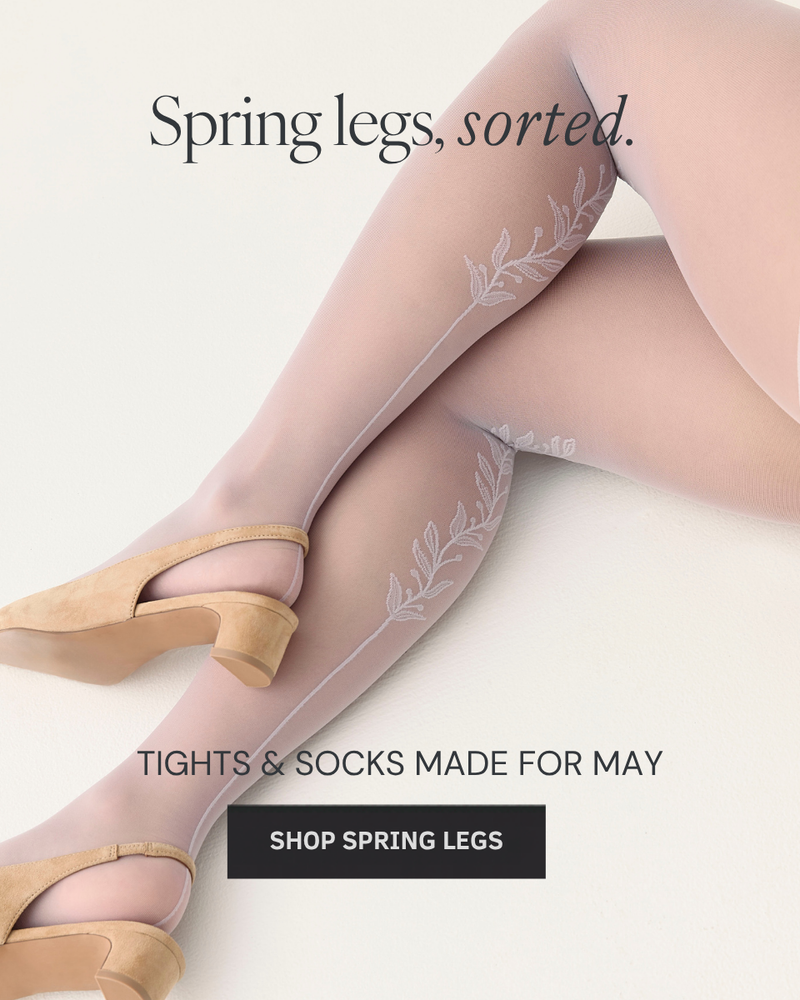 Sheer tights with floral design and high heels on a light background, promoting spring legs.