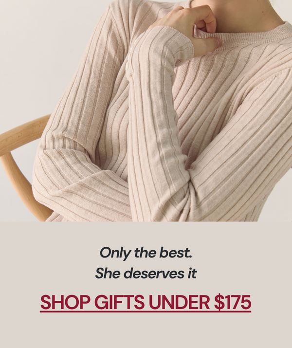 Person wearing a beige ribbed sweater with promotional text 